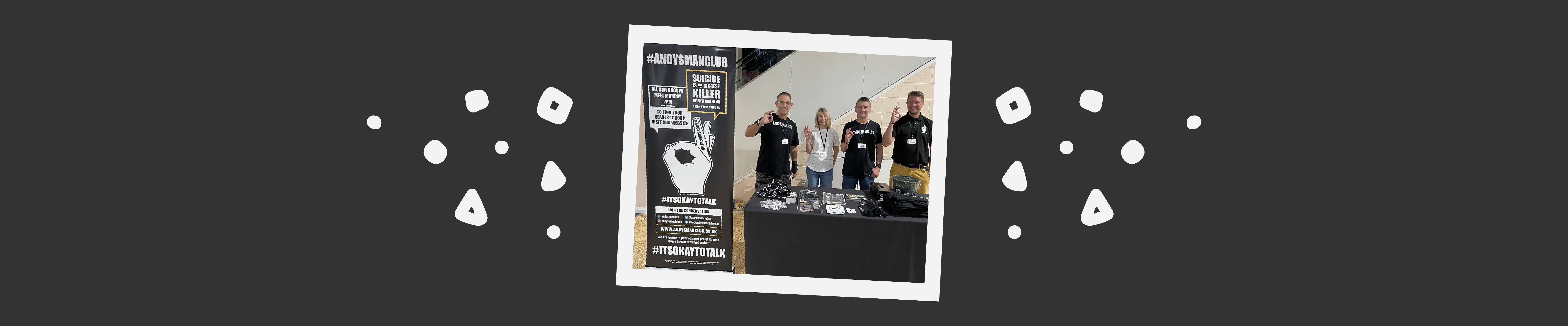 ANDYSMANCLUB volunteers at a stand in a shopping centre